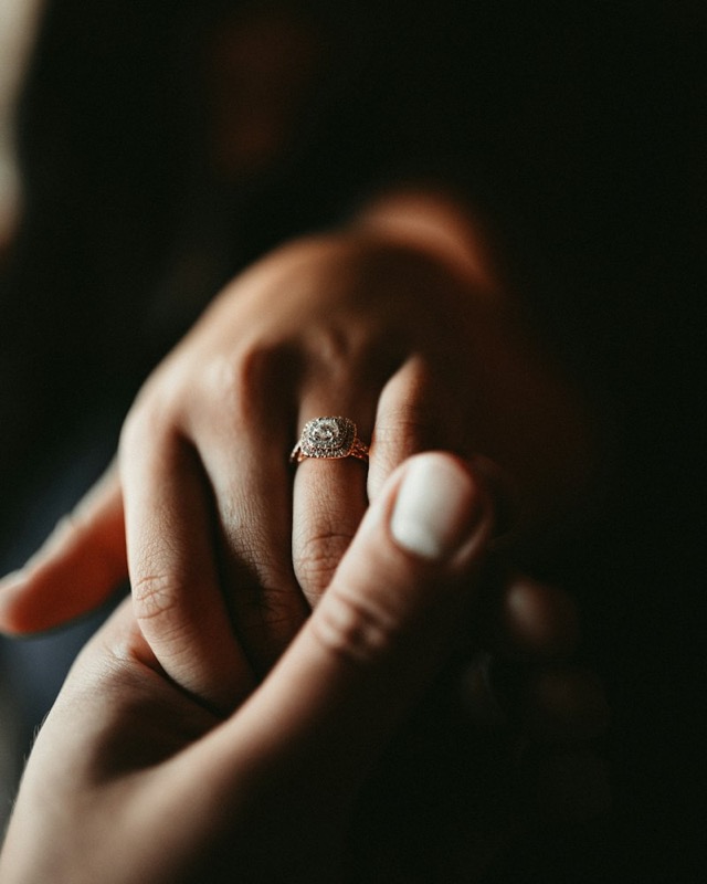 Close-up of a hand wearing a diamond engagement ring