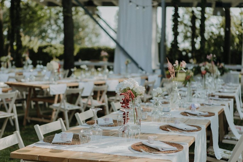 Long reception tables set with candles and florals