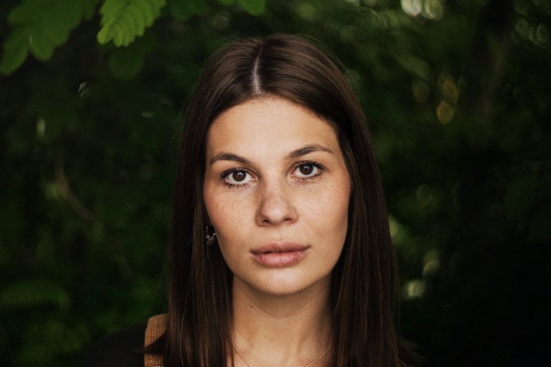 Portrait of a woman framed by green leaves