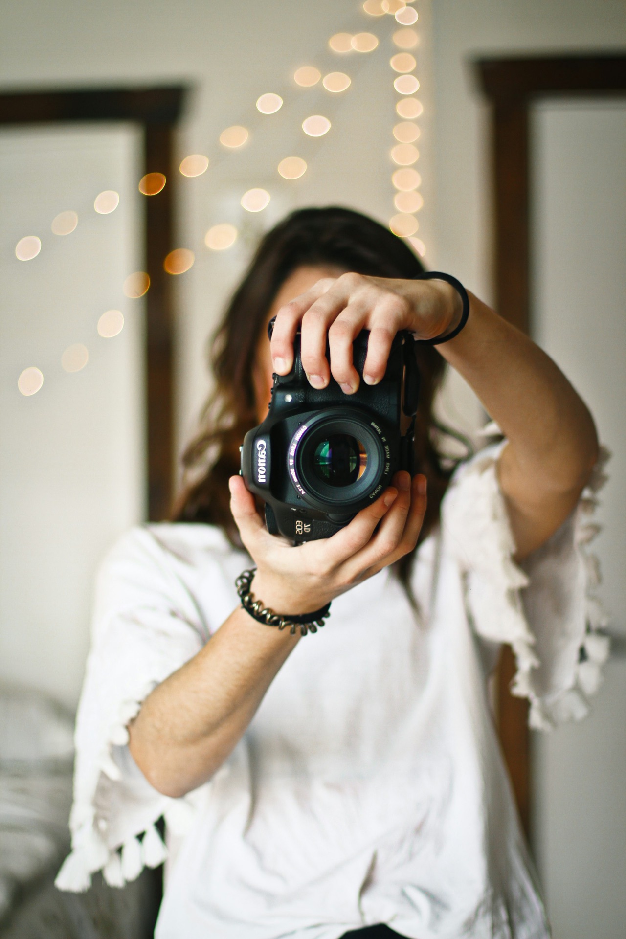 A woman holding a camera up toward the viewer